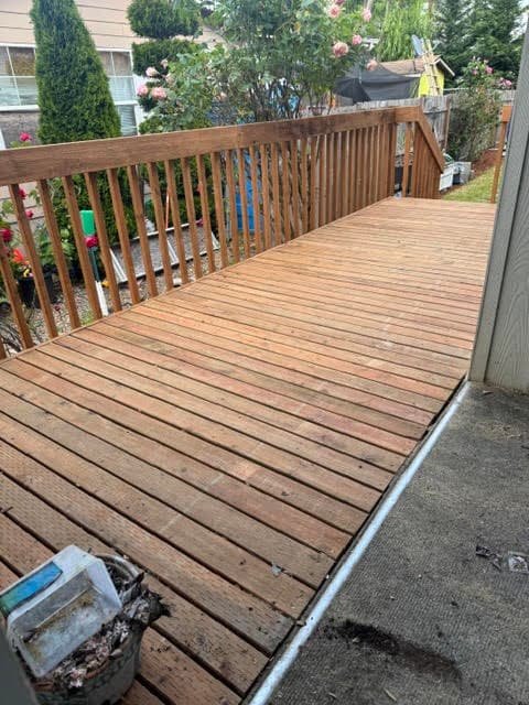 New cedar deck boards and wood railing overlooking a backyard