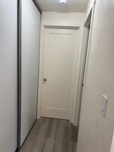 New white interior panel door installed with fresh trim