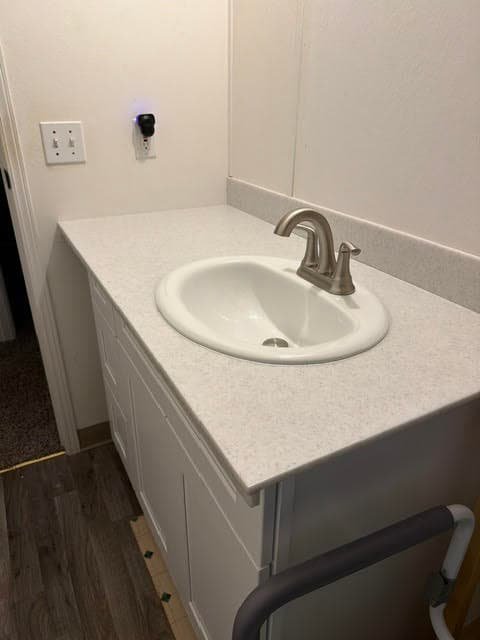 Close-up of a new white sink and brushed nickel faucet on a light countertop